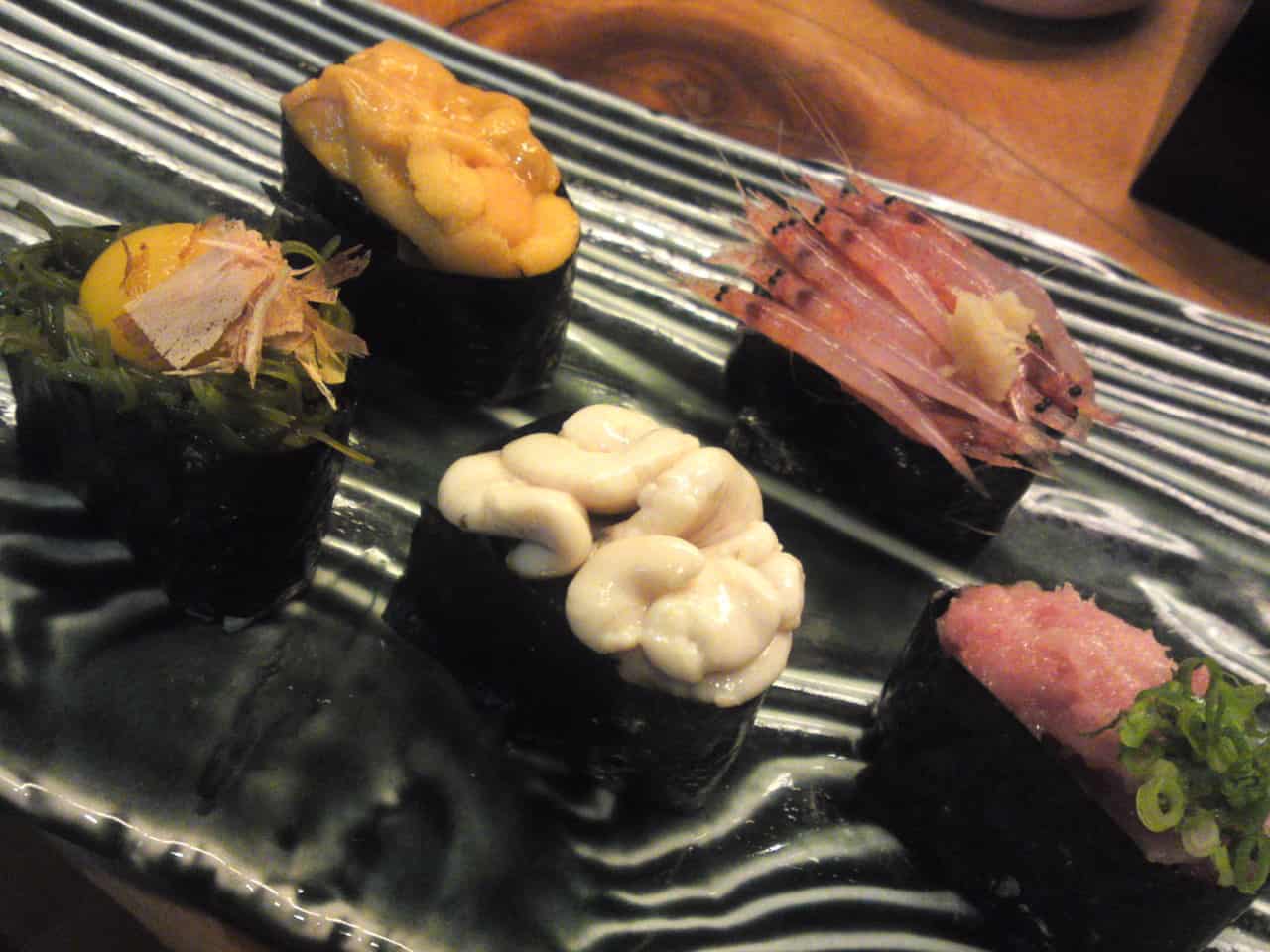 From top and left: “Uni/Sea Urchin”, “Sakura ebi/Cherry shrimps), “Uzura/Quail egg” with seaweed and dry bonito shavings, “Shirako/male cod milt”, and “Negitoro/Grated tuna” gunkan!