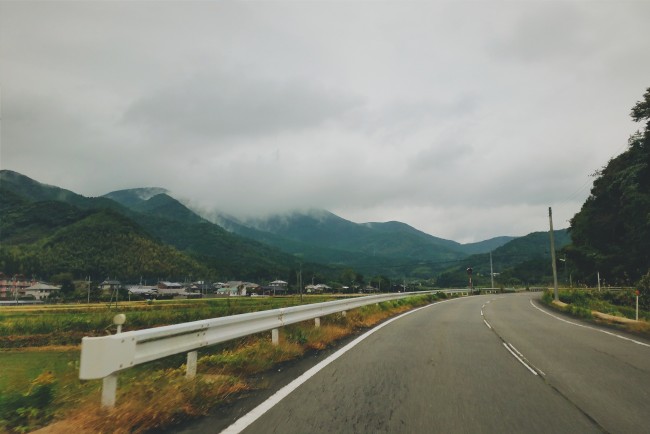 Pavement road with the countryside as background.