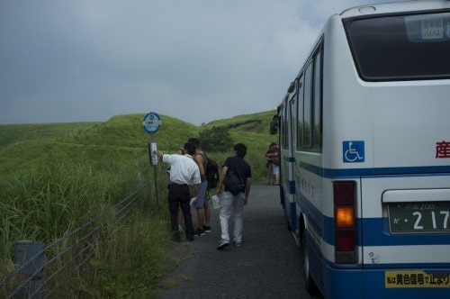 Checking the timetable in Mount Aso bus stop