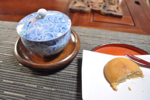 Enjoying Kyushu's famous dessert sweet and tea out of a teacup