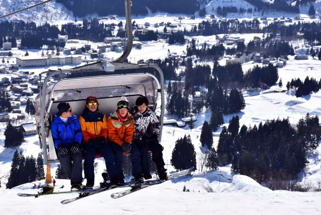 Some teenagers are taking the lift up to the top at Suhara ski-resort