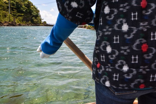 The boat driver wears the traditional dress, accompanied the same nice hat