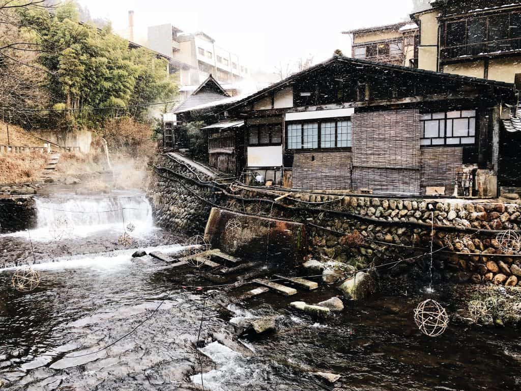 old traditional bathhouse built along a flowing river