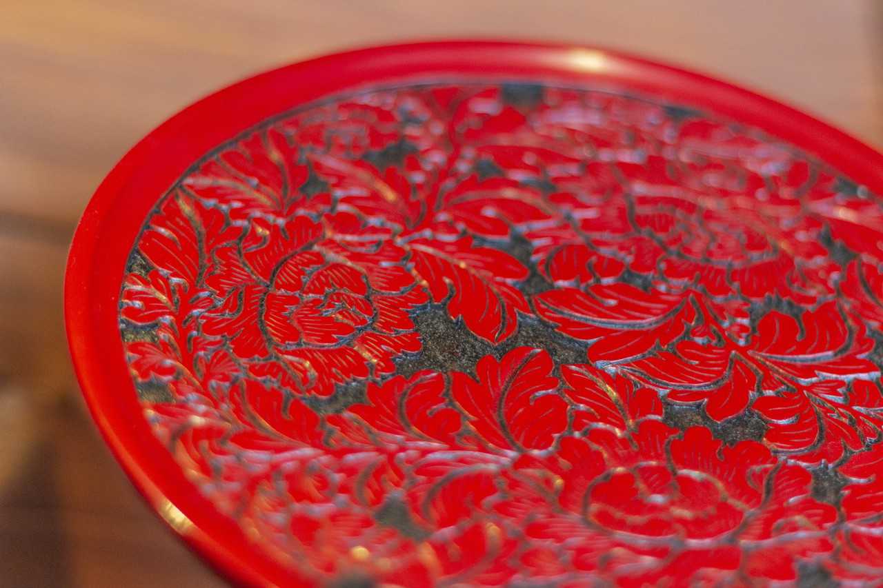 close up of red Lacquerware on traditional japanese wooden plate
