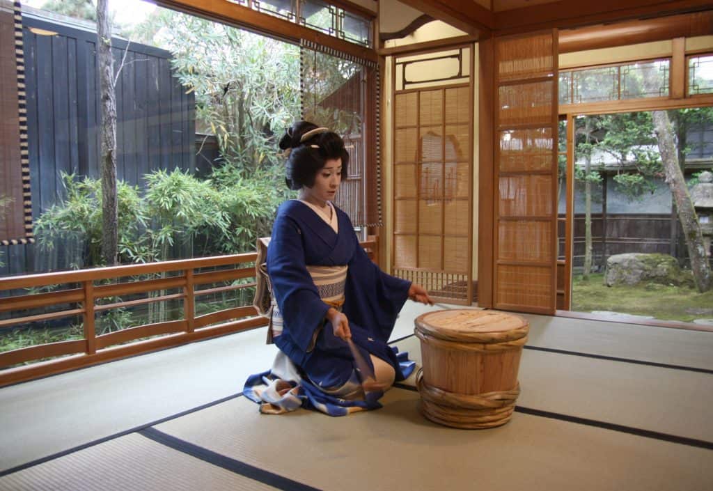Geisha playing a traditional Japanese instrument in Japan