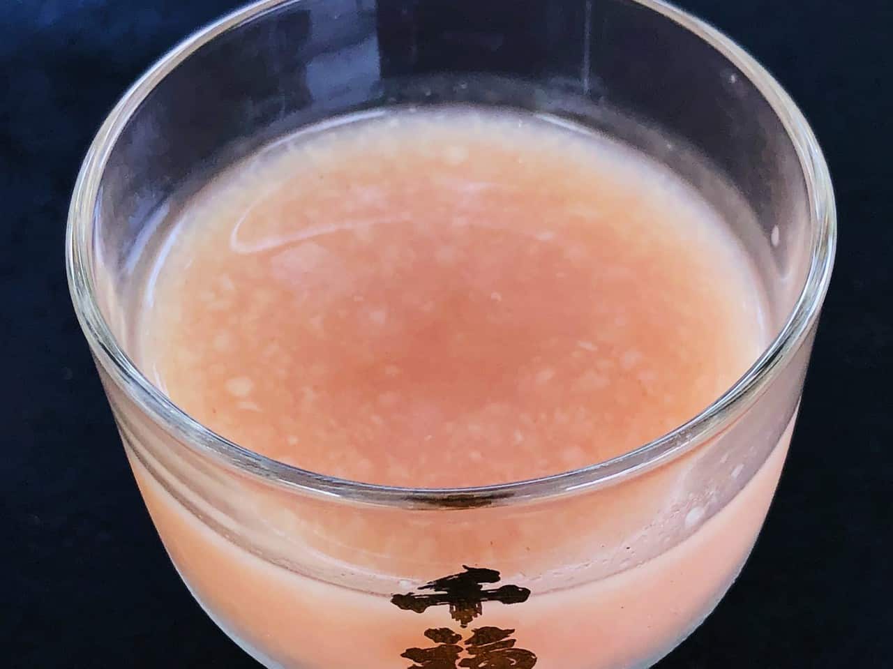 Visible lumps at the surface of  rosé doburoku, an unfiltered sake in Japan

