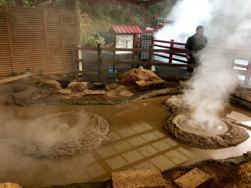 Kamado Jigoku includes boiling mud vents and large pools of water colored orange and an acidic light blue. 