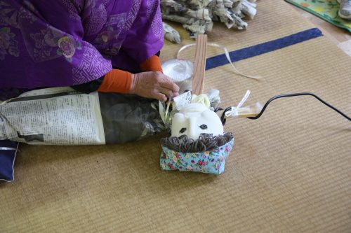 Mrs. Tsukimi, the creator of Nagoro's scarecrow population demonstrates her craft.