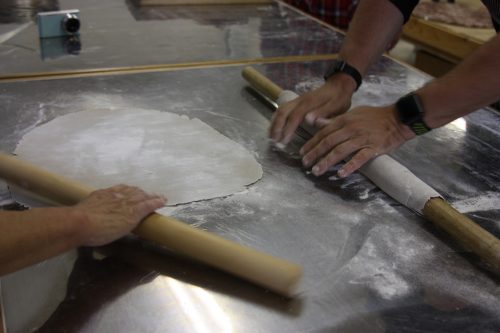 Rolling out the dough to make homemade soba noodles.