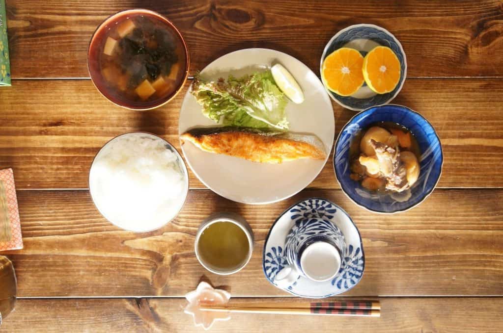 Traditional Japanese meal with rice, fish, and miso soup, served during a farmstay in Japan