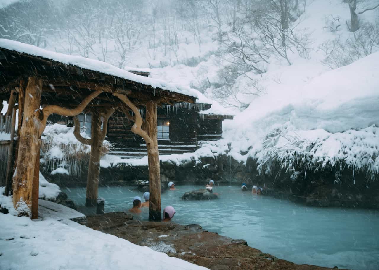 Bathers enjoy the onsen and snow at Tsurunoyu in Nyuto onsen, Akita, Tohoku, Japan.