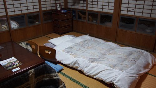 A traditional futon on the tatami floor.