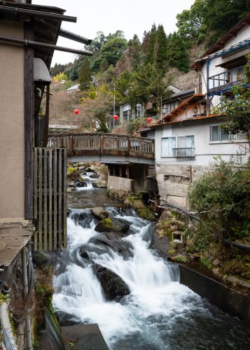 river with bridge in Japanese hot spring town