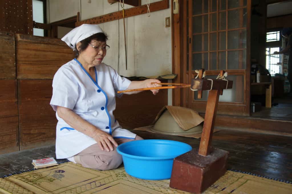 Mrs Igata, showing how to use a traditional tool to make somen noodles