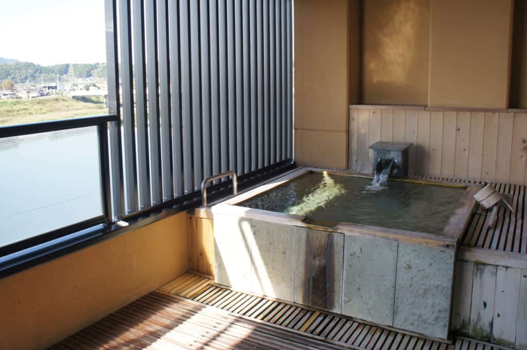 Private onsen on the terrace overlooking the river in Yamaga