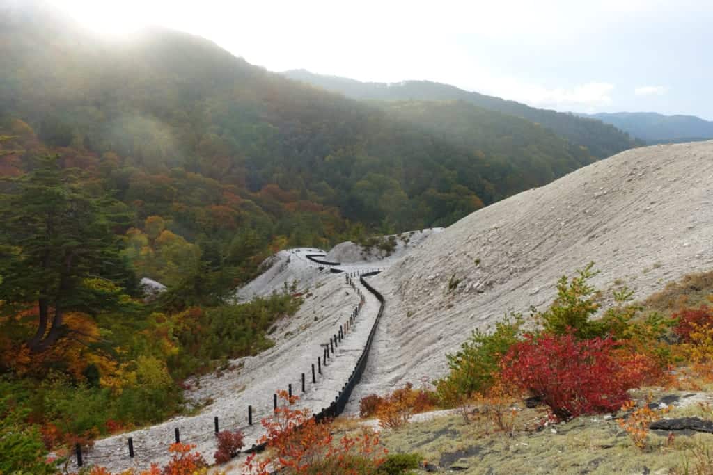 Surprising landscape of all-white jigoku kawarage in the middle of Tohoku's lush nature