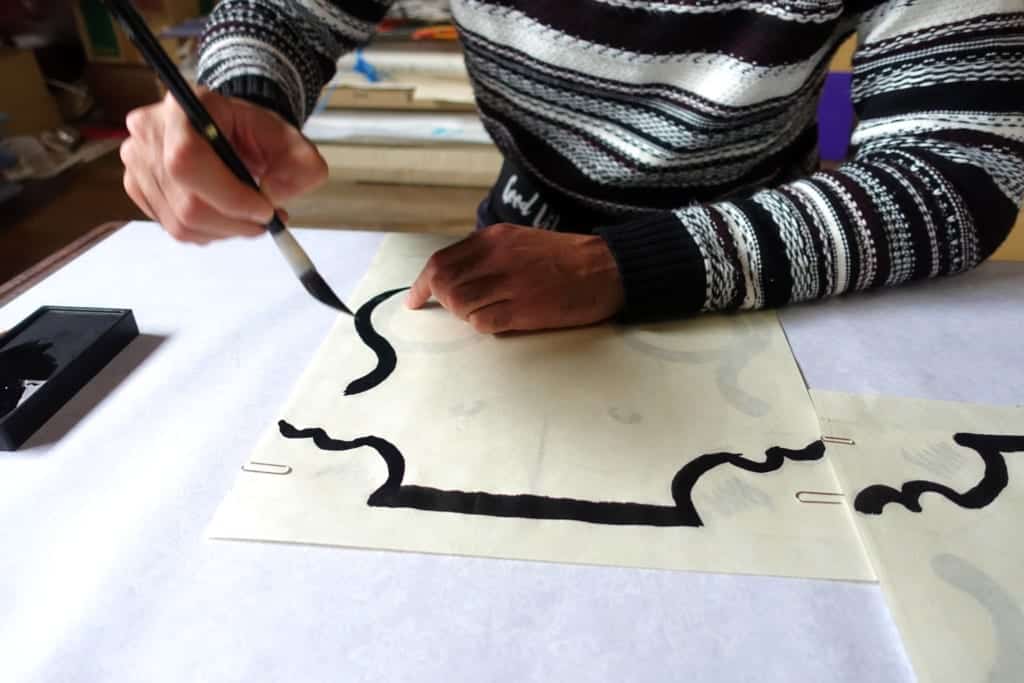 The outlines of the traditional kite patterns drawn in sumi ink