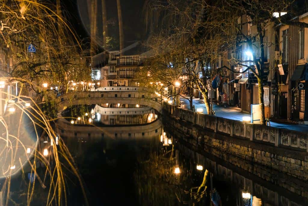 Night view of willow-lined canal at Kinosaki Onsen