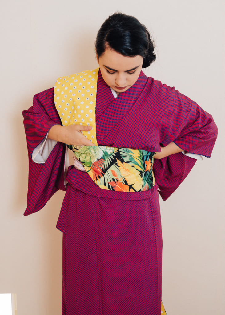 drape obi over shoulder and make a 45 degree fold