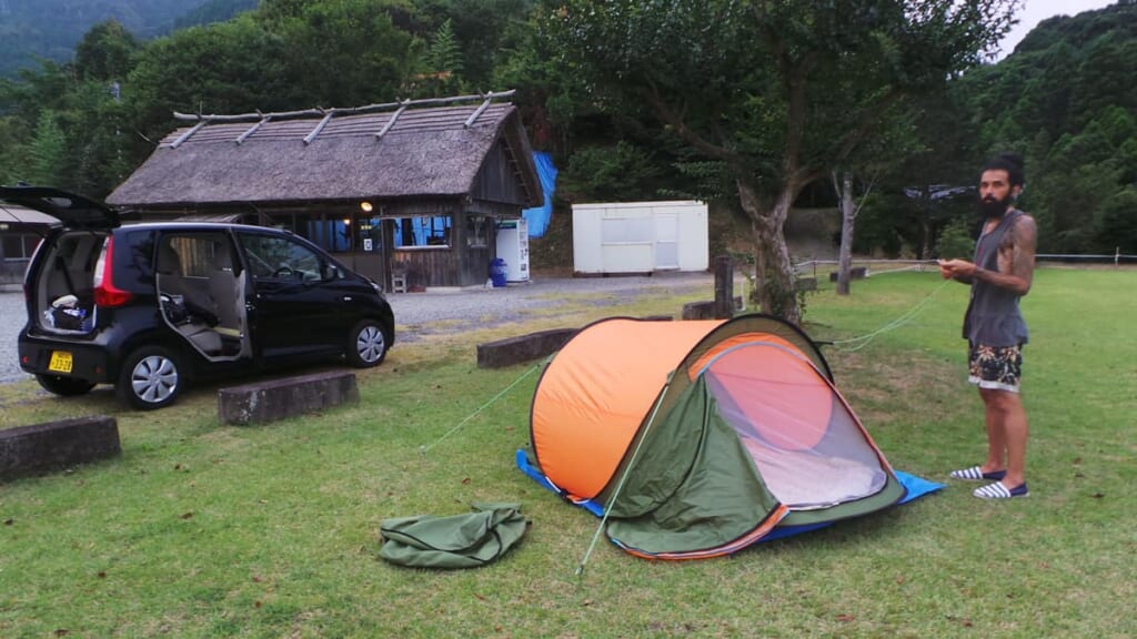 pitching the tent at a Japan campsite