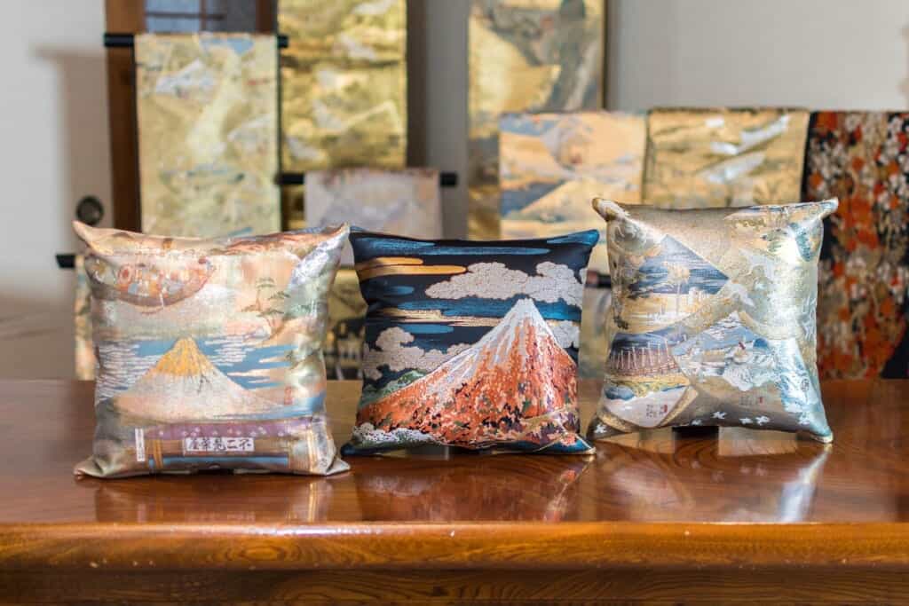 Vintage obi depicting scenes of Hiroshige Utagawa's 53 Stations of the Tokaido reconstructed into cushions