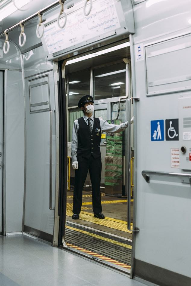 japanese train staff wearing face masks