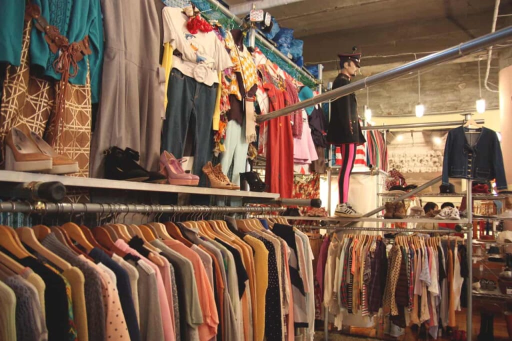 rails of vintage clothing in a thrift store