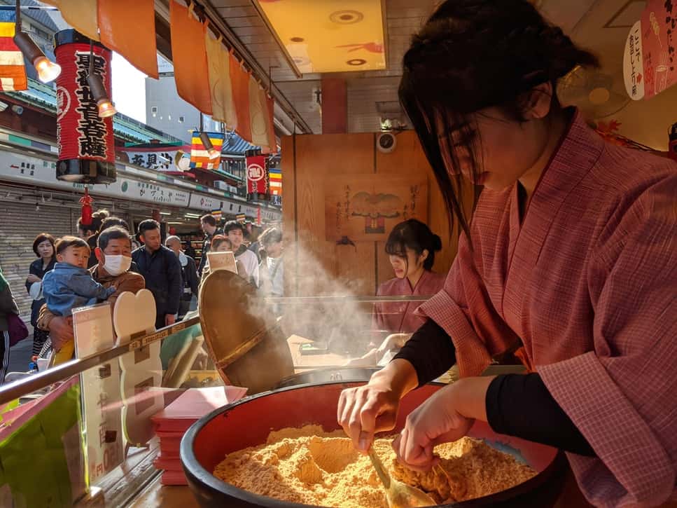 A girl cooking kibi dango in Asakusa, Tokyo