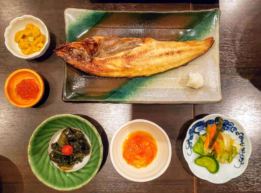 Grilled local mackerel, fresh sea urchin, and simmering seafood nabe pots at Rera Mosir on Rishiri Island, Hokkaido