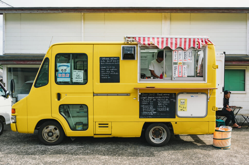 Bright yellow food truck of Flourjams on Ojika Island