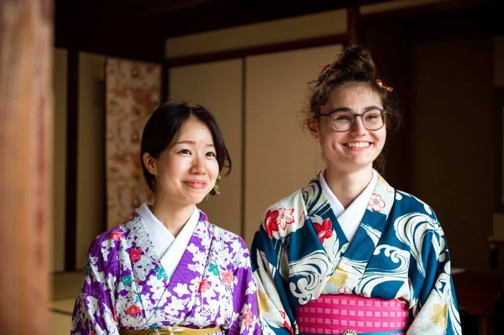 A Japanese and a Western women wearing colorful vintage kimonos