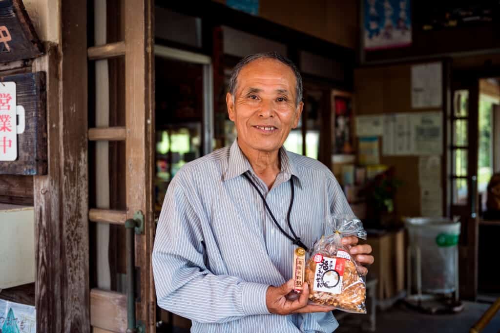 Japanese man holding senbei (Japanese rice crackers)