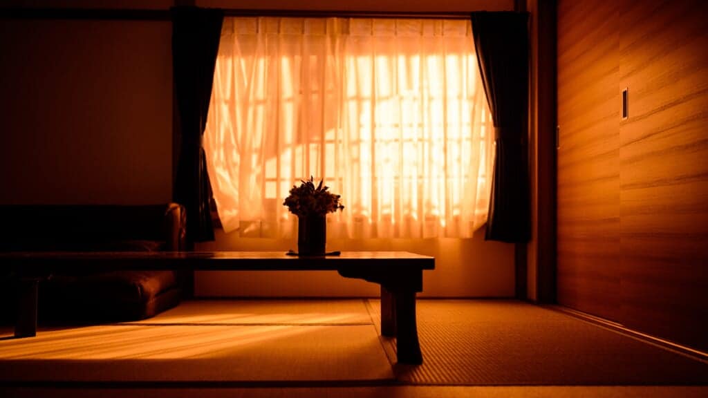 Inside a tatami room, in the orange light of the sunset