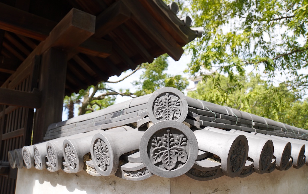 Ridge-end tiles on the reconstructed Gate at the Top of Sixty-one Steps