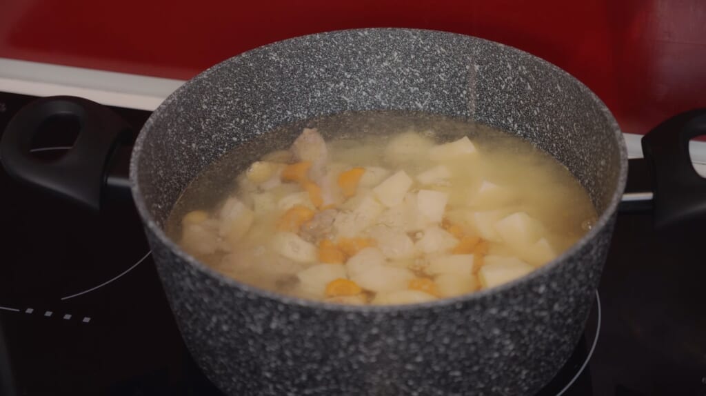 meat and vegetables cooking in a saucepan