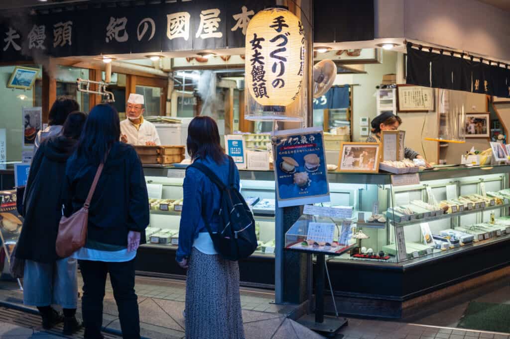 shoppers at a shop on bentaizen nakamise street enoshima island