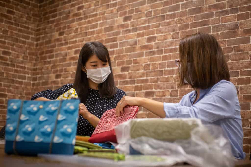 MinaHomi and Yurubia checking their Japanese textiles