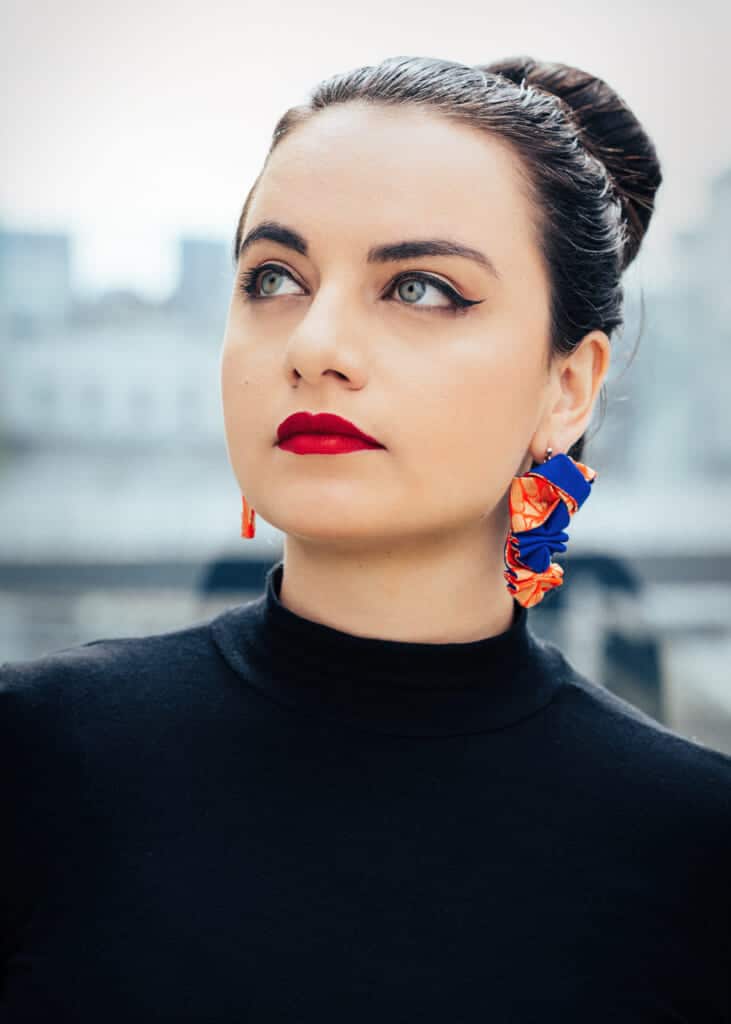 woman models oriobi earrings