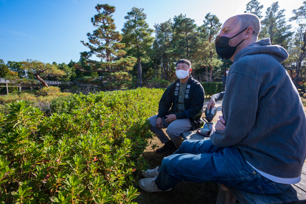 Staying safe with masks while enjoying tea in a Japanese Garden  near Kyoto