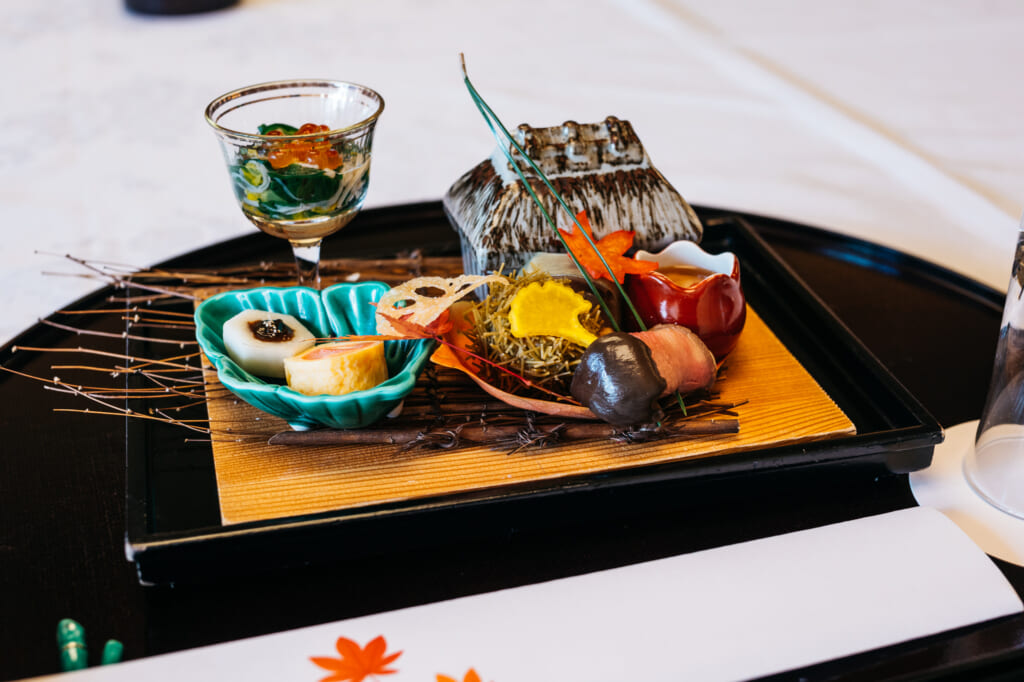 Traditional Japanese kaiseki cuisine dish with autumn theme 