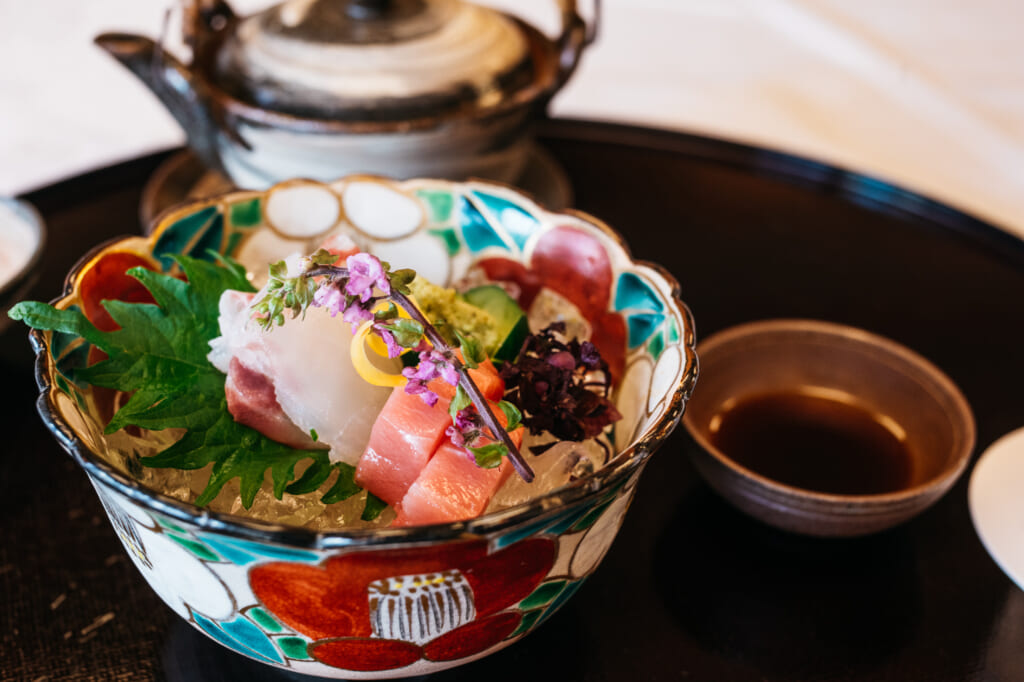 Traditional Japanese dish with raw sashimi during a kaiseki cusine meal