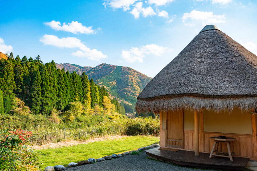 Mountain view with traditional  Japanese thatched roof house in Miyama