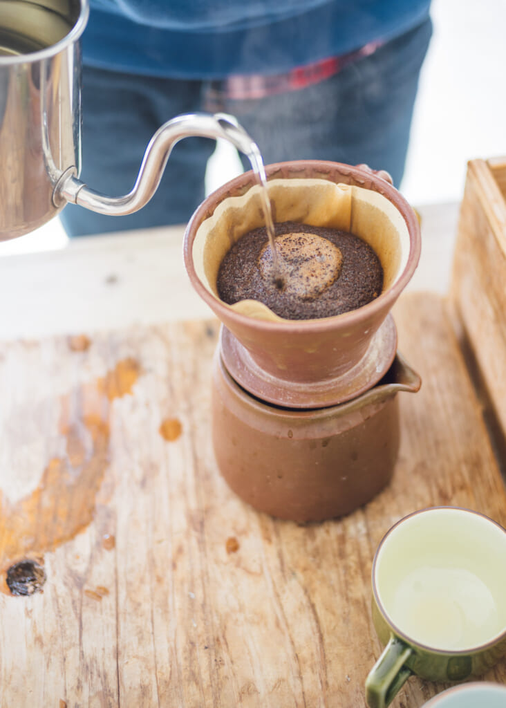 pouring coffee through traditional usuki ceramics