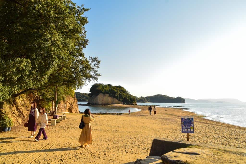 people walking on beach along Angel Road  on Shodoshima, Shikoku island 