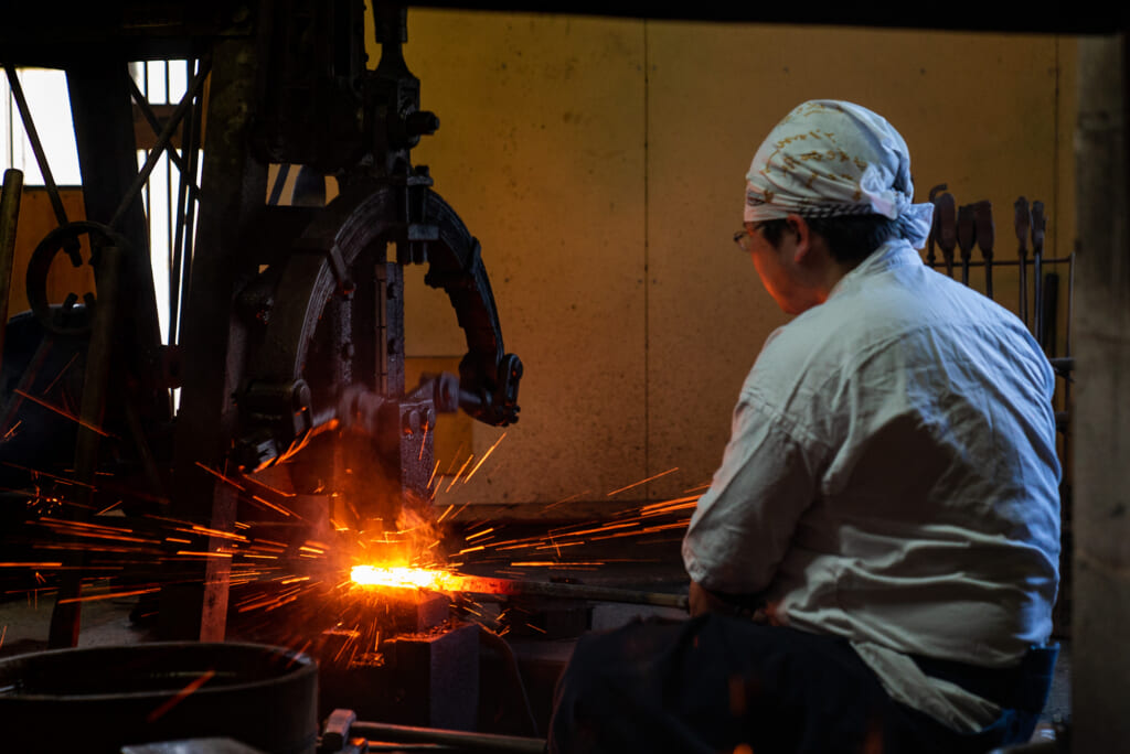 swordsmith working on a japanese sword