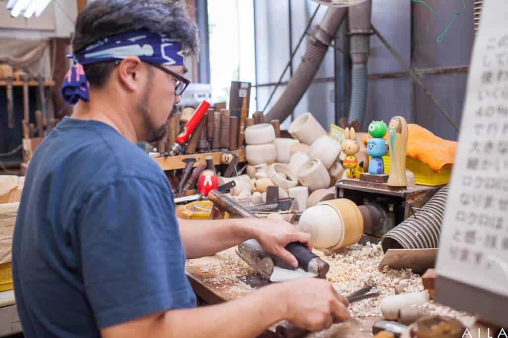 Artisan from Usaburo Kokeshi making a kokeshi doll 