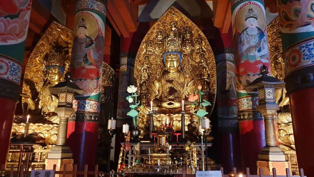 Japanese Buddhist gold statues among painted columns