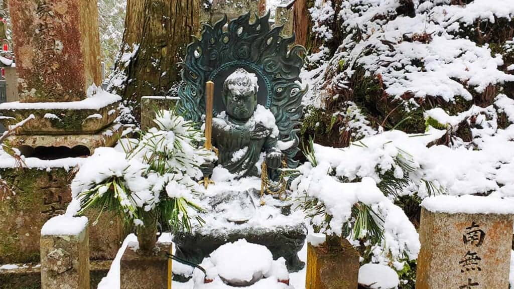 Statue of the Buddhist divinity Fudo Myoo in the snow