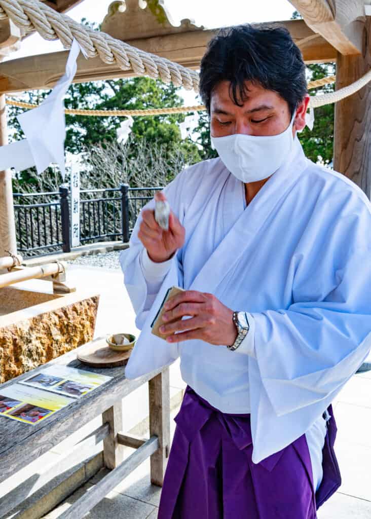 Japanese shrine priest shows purification by fire at akihasan jinja in Japan