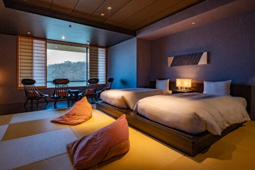Luxury Japanese guest room with tatami and beds at hoshino resorts kai enshu in Japan